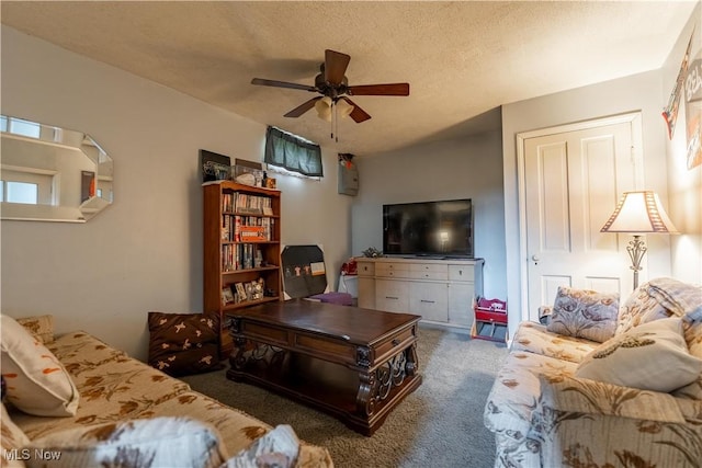 carpeted living room with a textured ceiling and a ceiling fan