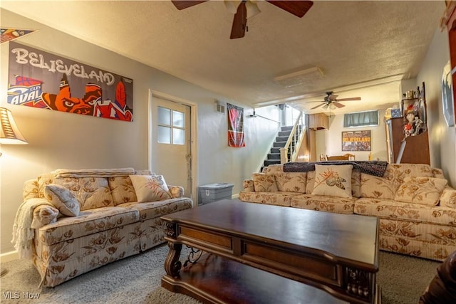 living room with stairs, carpet, visible vents, and ceiling fan