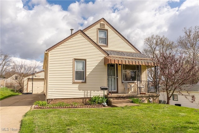 bungalow-style home with concrete driveway, roof with shingles, a front yard, a garage, and covered porch