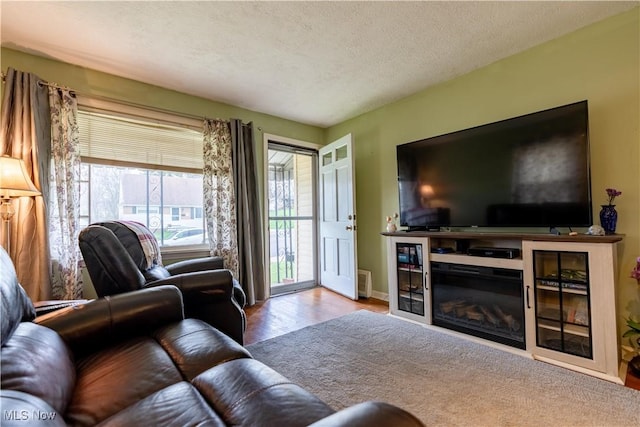 living area featuring a textured ceiling