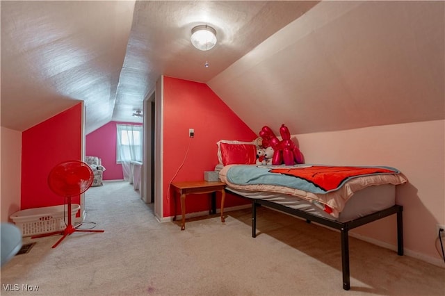 bedroom featuring carpet flooring, baseboards, and vaulted ceiling