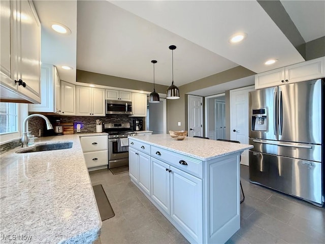 21 Ashwood Dr, Vienna, WV 26105 - kitchen with appliances with stainless steel finishes, a sink, tasteful backsplash, a kitchen island, and light tile patterned floors