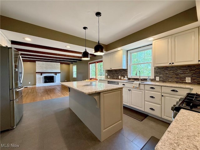 21 Ashwood Dr, Vienna, WV 26105 - kitchen featuring stainless steel refrigerator with ice dispenser, a sink, open floor plan, white cabinetry, and tasteful backsplash
