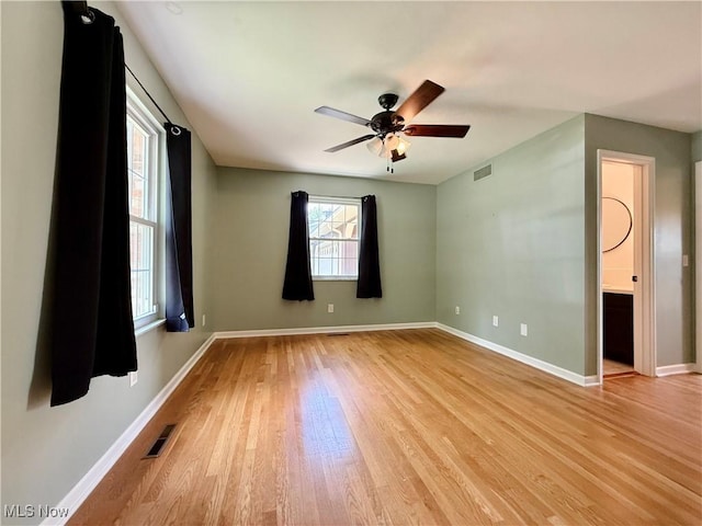 21 Ashwood Dr, Vienna, WV 26105 - unfurnished room featuring plenty of natural light, light wood finished floors, a ceiling fan, and baseboards
