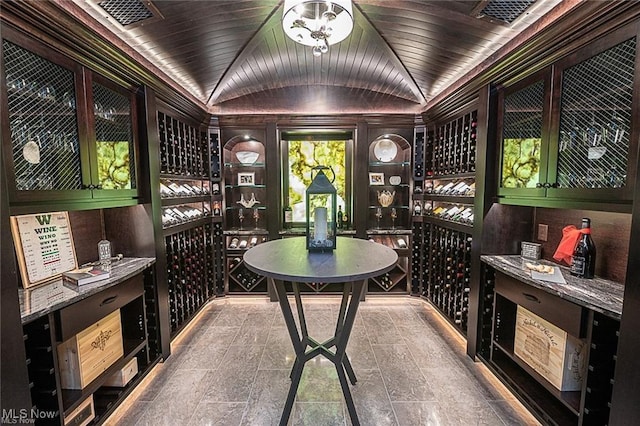 wine area featuring lofted ceiling and visible vents