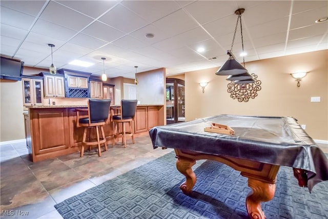game room featuring indoor wet bar, pool table, tile patterned flooring, and a drop ceiling