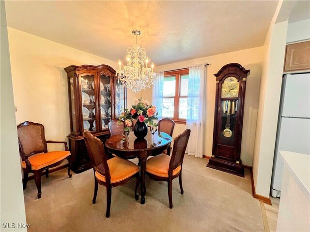 126 Vine St, Mingo Junction, OH 43938 - dining space with light carpet, baseboards, and an inviting chandelier