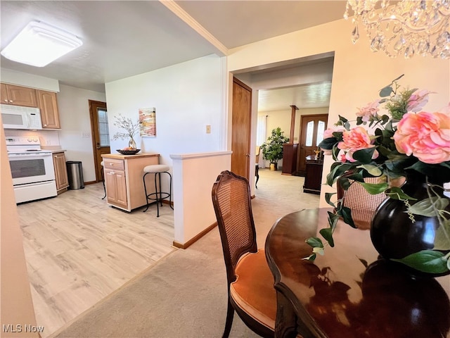 126 Vine St, Mingo Junction, OH 43938 - dining room featuring a chandelier, light wood finished floors, light colored carpet, and baseboards