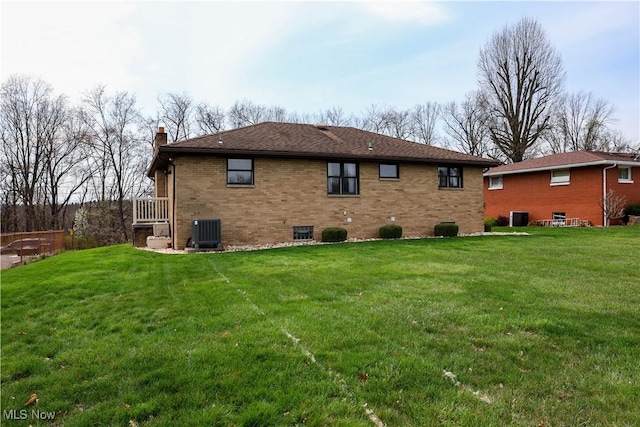 126 Vine St, Mingo Junction, OH 43938 - back of property with a yard, a chimney, brick siding, and central air condition unit