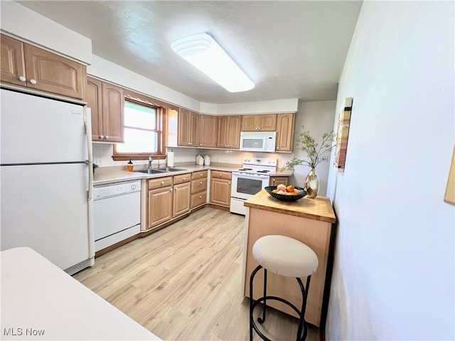 126 Vine St, Mingo Junction, OH 43938 - kitchen featuring white appliances, light countertops, a sink, and light wood finished floors