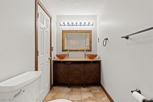 5215 Glenbrook Dr, Vienna, WV 26105 - full bath with toilet, a sink, double vanity, and baseboards