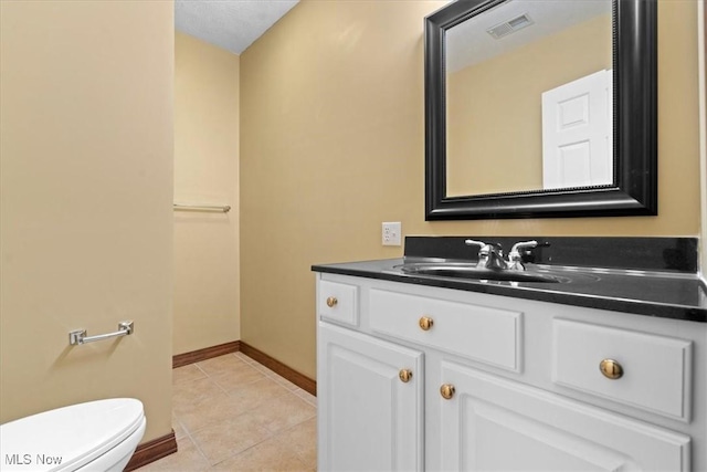 5215 Glenbrook Dr, Vienna, WV 26105 - half bath with tile patterned floors, visible vents, toilet, vanity, and baseboards