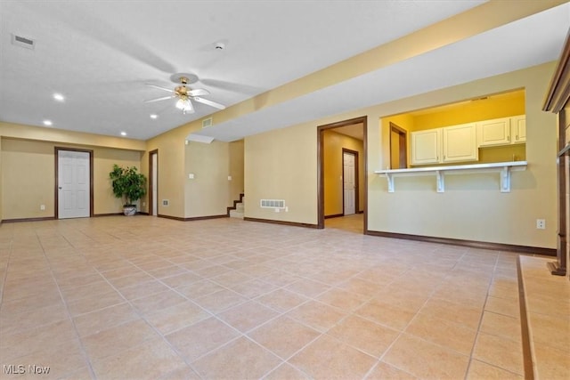 5215 Glenbrook Dr, Vienna, WV 26105 - unfurnished living room with baseboards, a ceiling fan, visible vents, and light tile patterned floors