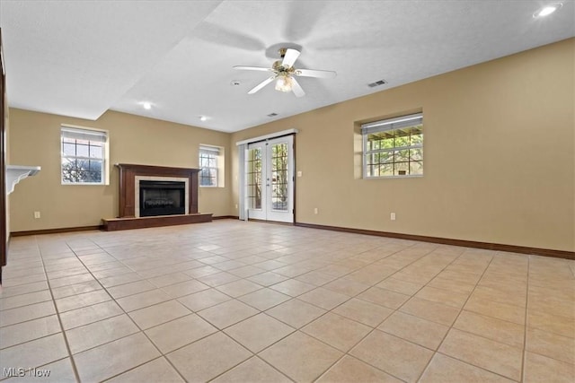 5215 Glenbrook Dr, Vienna, WV 26105 - unfurnished living room featuring a fireplace with raised hearth, visible vents, a ceiling fan, light tile patterned flooring, and baseboards