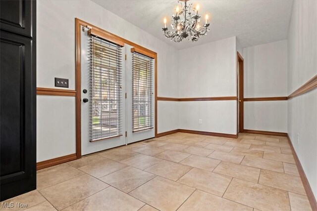 5215 Glenbrook Dr, Vienna, WV 26105 - unfurnished dining area with a chandelier, baseboards, and light tile patterned flooring