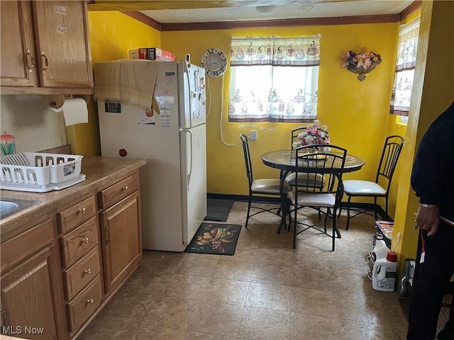 152 Regent St, Youngstown, OH 44507 - kitchen featuring brown cabinets and freestanding refrigerator