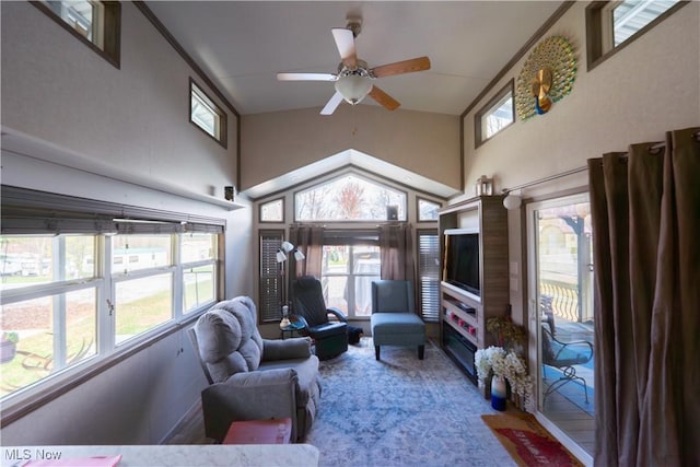 living area featuring carpet floors, high vaulted ceiling, and a ceiling fan