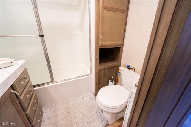 bathroom with combined bath / shower with glass door, vanity, and toilet