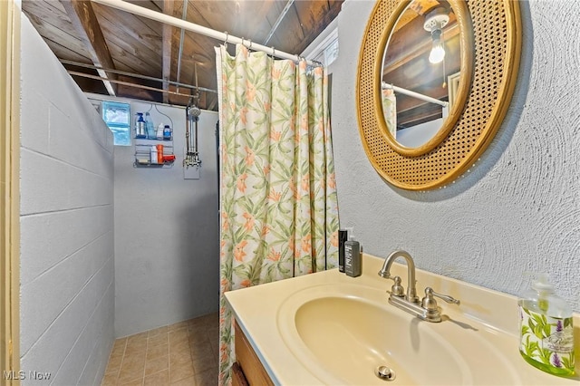 bathroom featuring vanity and a shower with shower curtain