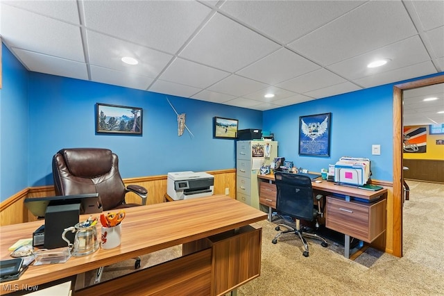 carpeted office featuring wainscoting, wooden walls, a drop ceiling, and recessed lighting