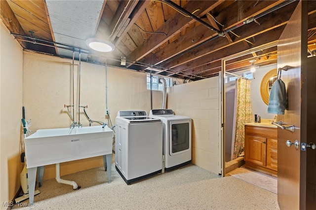 washroom featuring a sink, independent washer and dryer, and laundry area