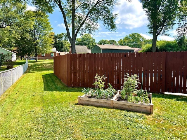 view of yard with a vegetable garden and fence