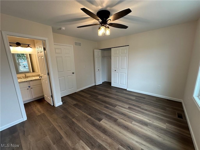 738 Mineral Springs Ave, Youngstown, OH 44511 - unfurnished bedroom with a sink, dark wood-type flooring, baseboards, and a closet