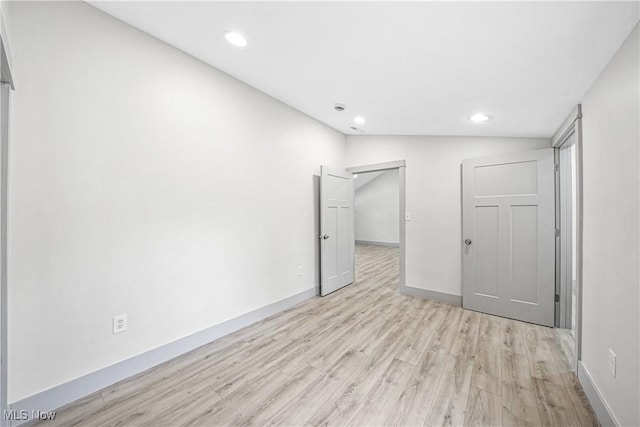 unfurnished bedroom featuring light wood finished floors, baseboards, and recessed lighting
