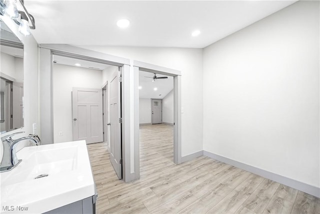 bathroom with baseboards, recessed lighting, a ceiling fan, wood finished floors, and vanity