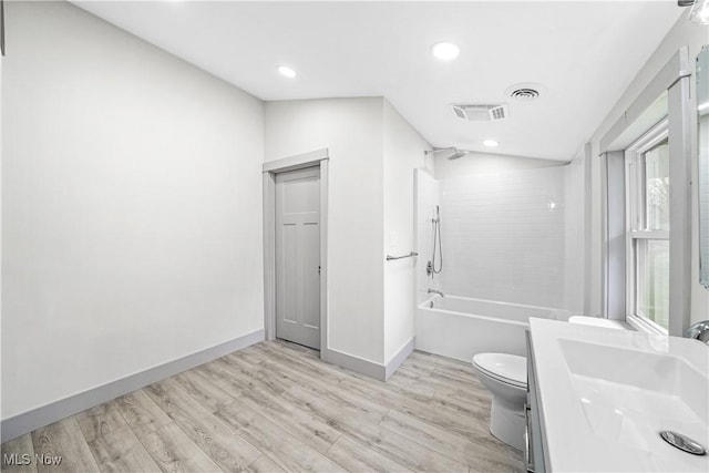full bathroom with shower / bath combination, toilet, wood finished floors, and visible vents