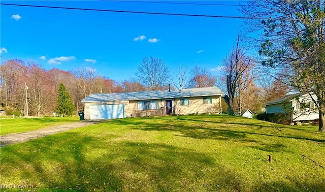 ranch-style home with an attached garage, driveway, and a front yard