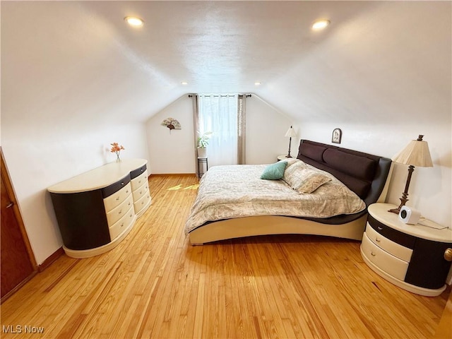 bedroom with recessed lighting, vaulted ceiling, light wood-style floors, and baseboards