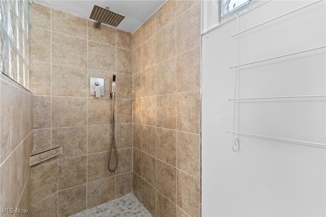 bathroom with tiled shower