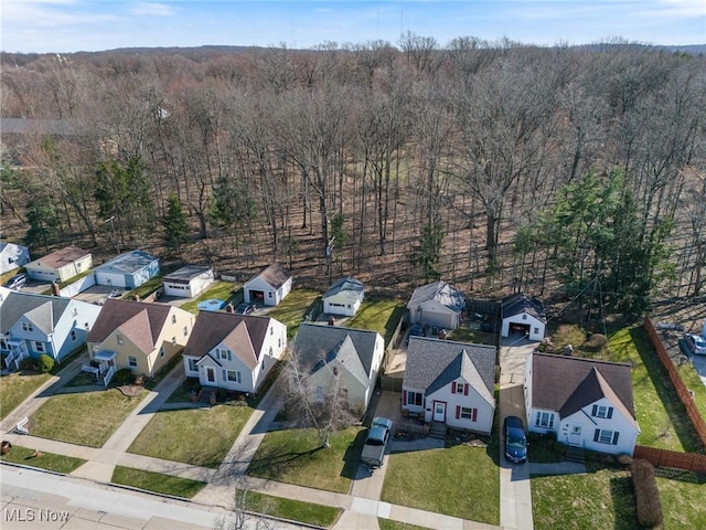 drone / aerial view with a residential view and a wooded view