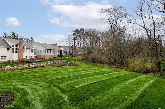 view of yard featuring a residential view and a water view