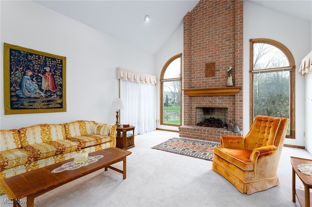 living area with a fireplace, a wealth of natural light, carpet flooring, and high vaulted ceiling