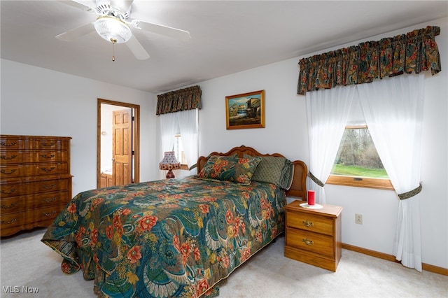 bedroom with light carpet, baseboards, and ceiling fan