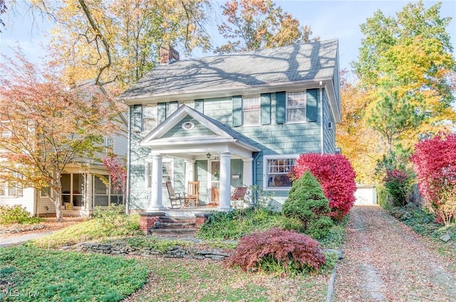 view of front of property featuring a porch and a chimney