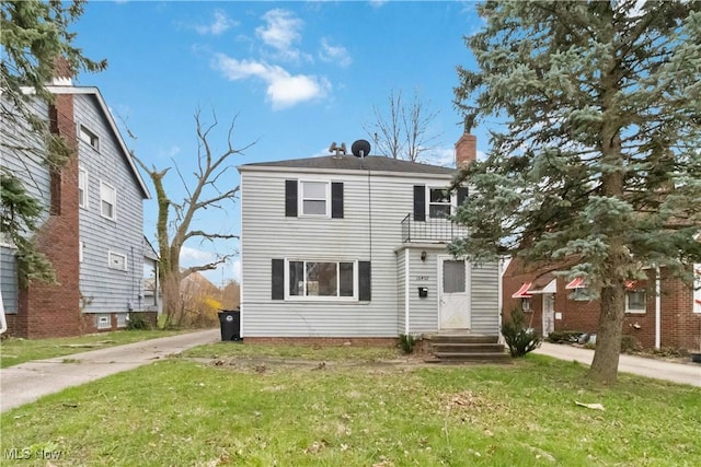 view of front of house with a chimney and a front yard