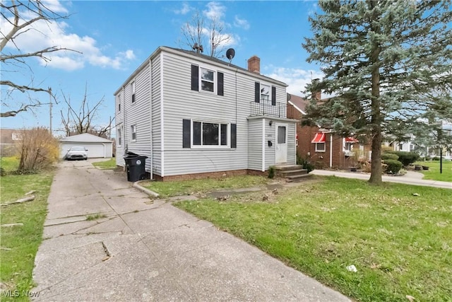 view of front of property with a chimney, an outdoor structure, a detached garage, and a front yard