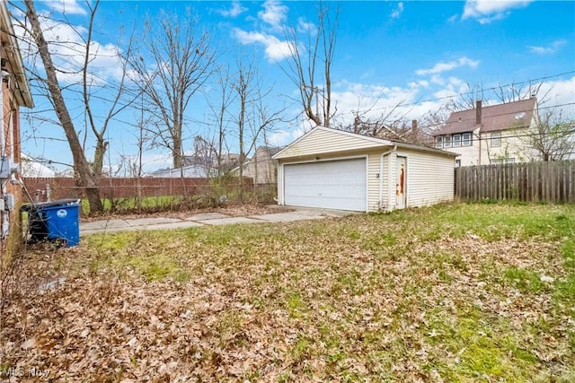 detached garage featuring fence