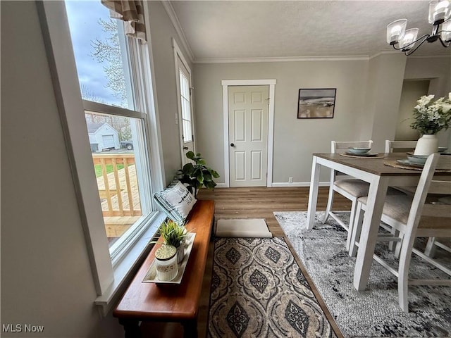 222 Smith St, Niles, OH 44446 - dining area featuring an inviting chandelier, ornamental molding, wood finished floors, and baseboards