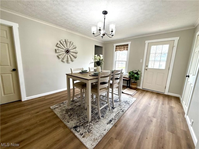 222 Smith St, Niles, OH 44446 - dining room with wood finished floors, a textured ceiling, baseboards, and a notable chandelier