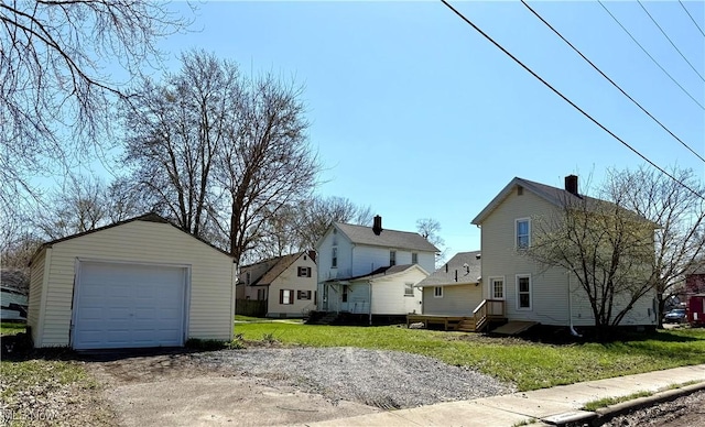 222 Smith St, Niles, OH 44446 - exterior space with dirt driveway, an outbuilding, a residential view, and a garage