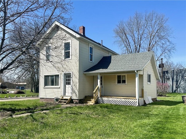222 Smith St, Niles, OH 44446 - rear view of property featuring a lawn, a shingled roof, a chimney, and entry steps