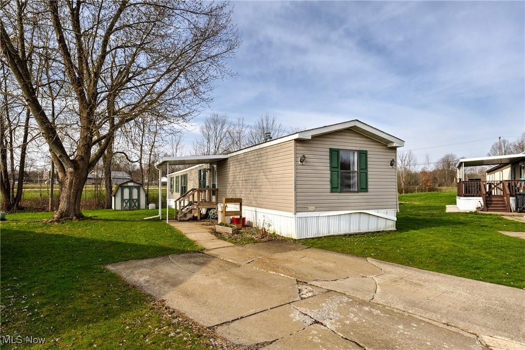 1030 S Park Dr, Brookfield, OH 44403 - exterior space with an outbuilding, a storage shed, and a front yard