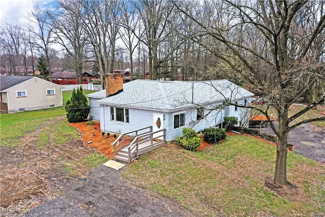 5099 Norquest Blvd, Youngstown, OH 44515 - ranch-style home with a front lawn, a chimney, and roof with shingles