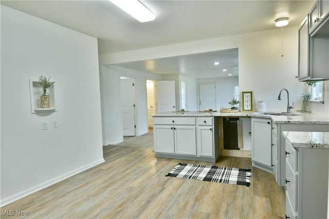 5099 Norquest Blvd, Youngstown, OH 44515 - kitchen featuring a peninsula, light wood-style flooring, a sink, recessed lighting, and light stone counters