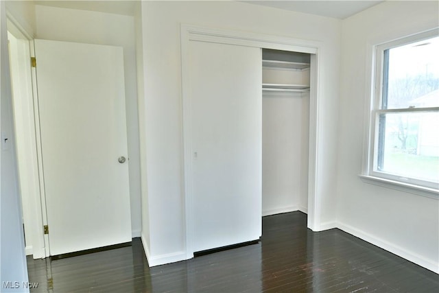 5099 Norquest Blvd, Youngstown, OH 44515 - unfurnished bedroom with wood finished floors, baseboards, a closet, and multiple windows