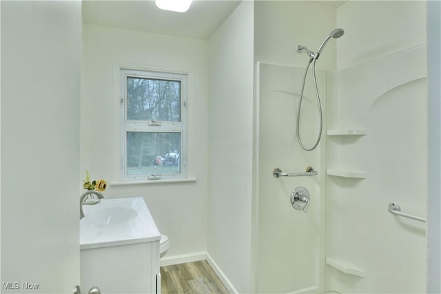 5099 Norquest Blvd, Youngstown, OH 44515 - bathroom with toilet, baseboards, wood finished floors, a shower, and vanity